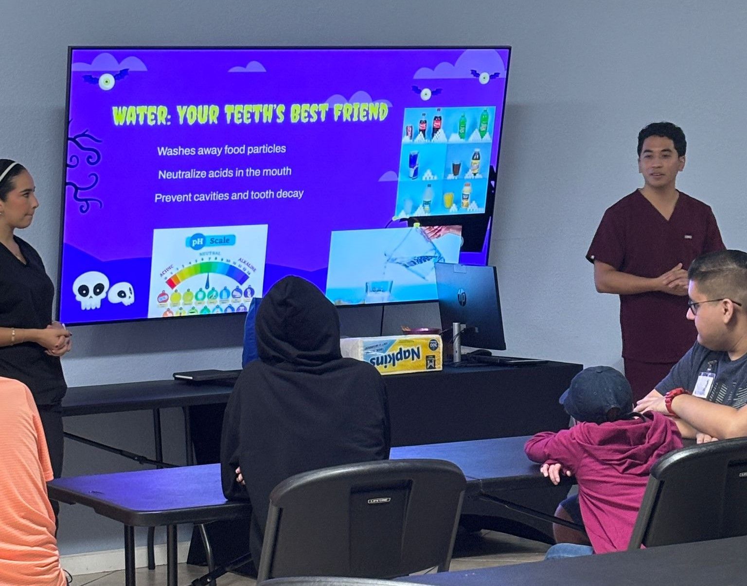 A group of people are sitting in front of a screen that says enter your poetry best friend