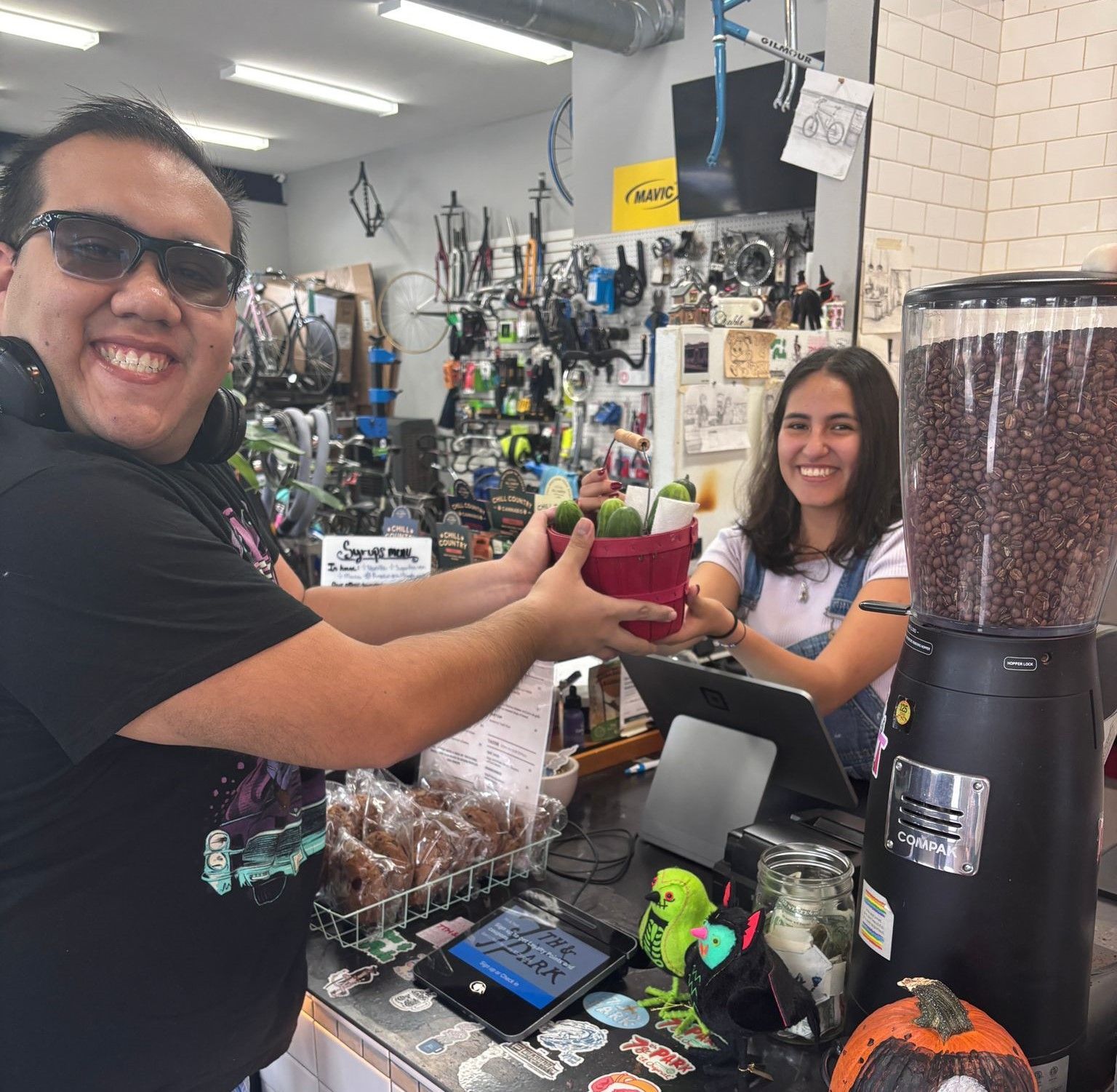 A man and a woman are standing in a store holding potted plants