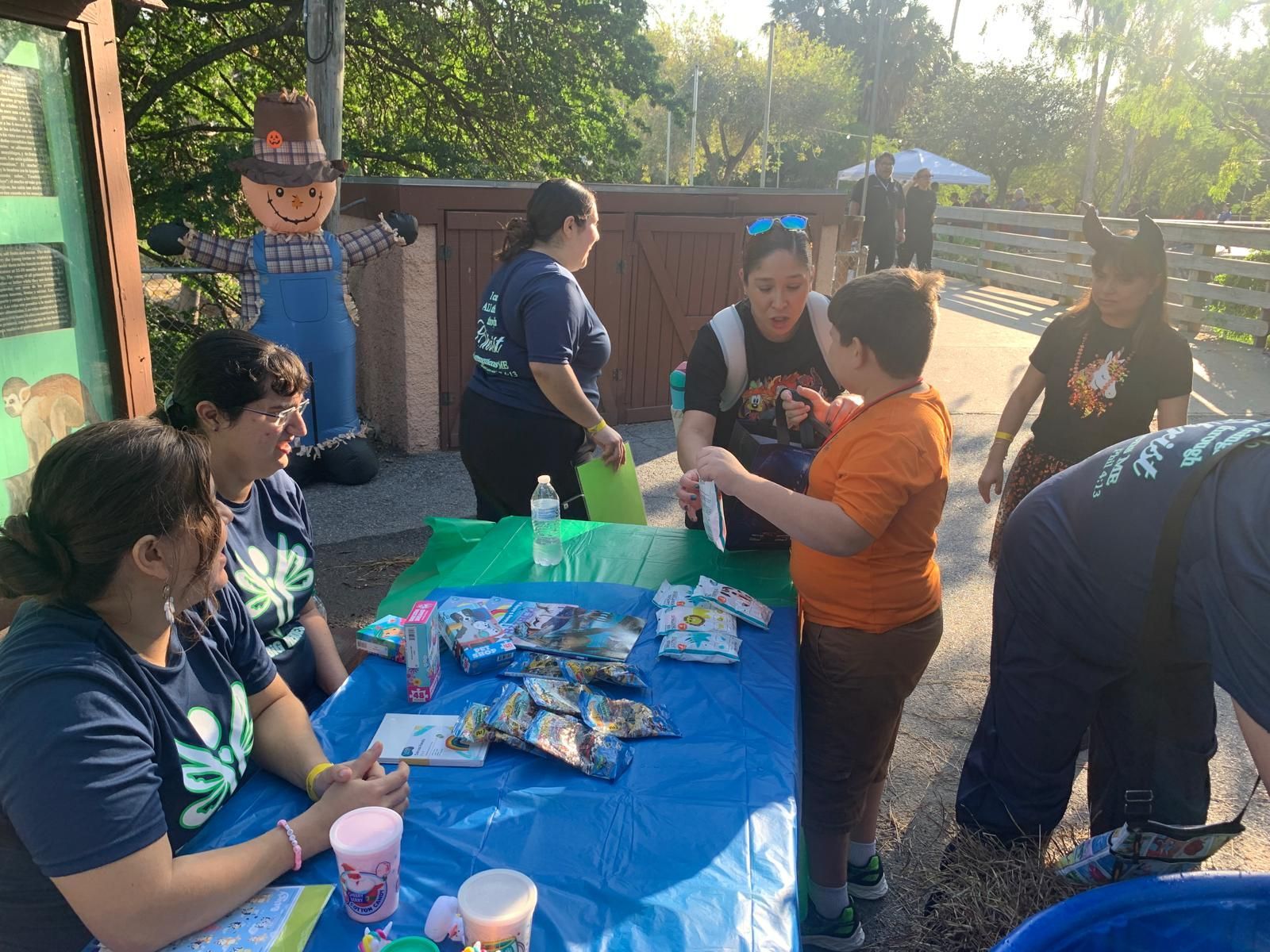 A group of people are standing around a table.