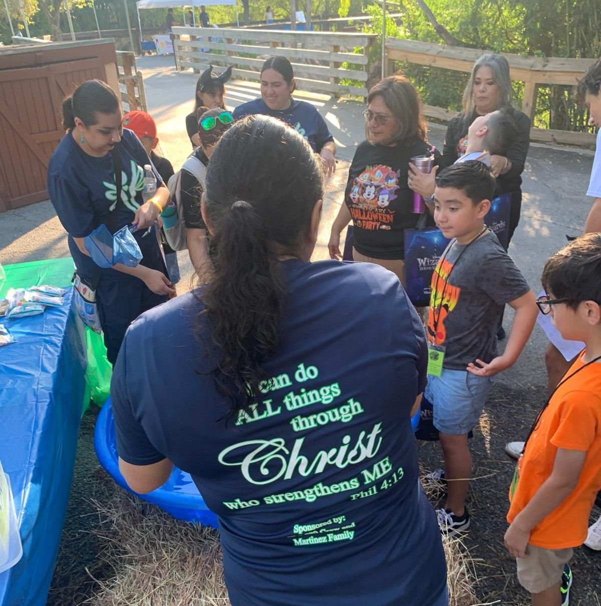 A woman wearing a shirt that says i can do all things through christ