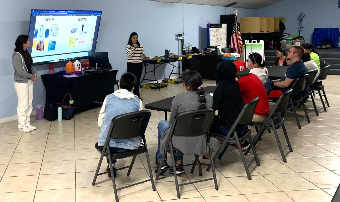 A woman is giving a presentation to a group of people in a room.