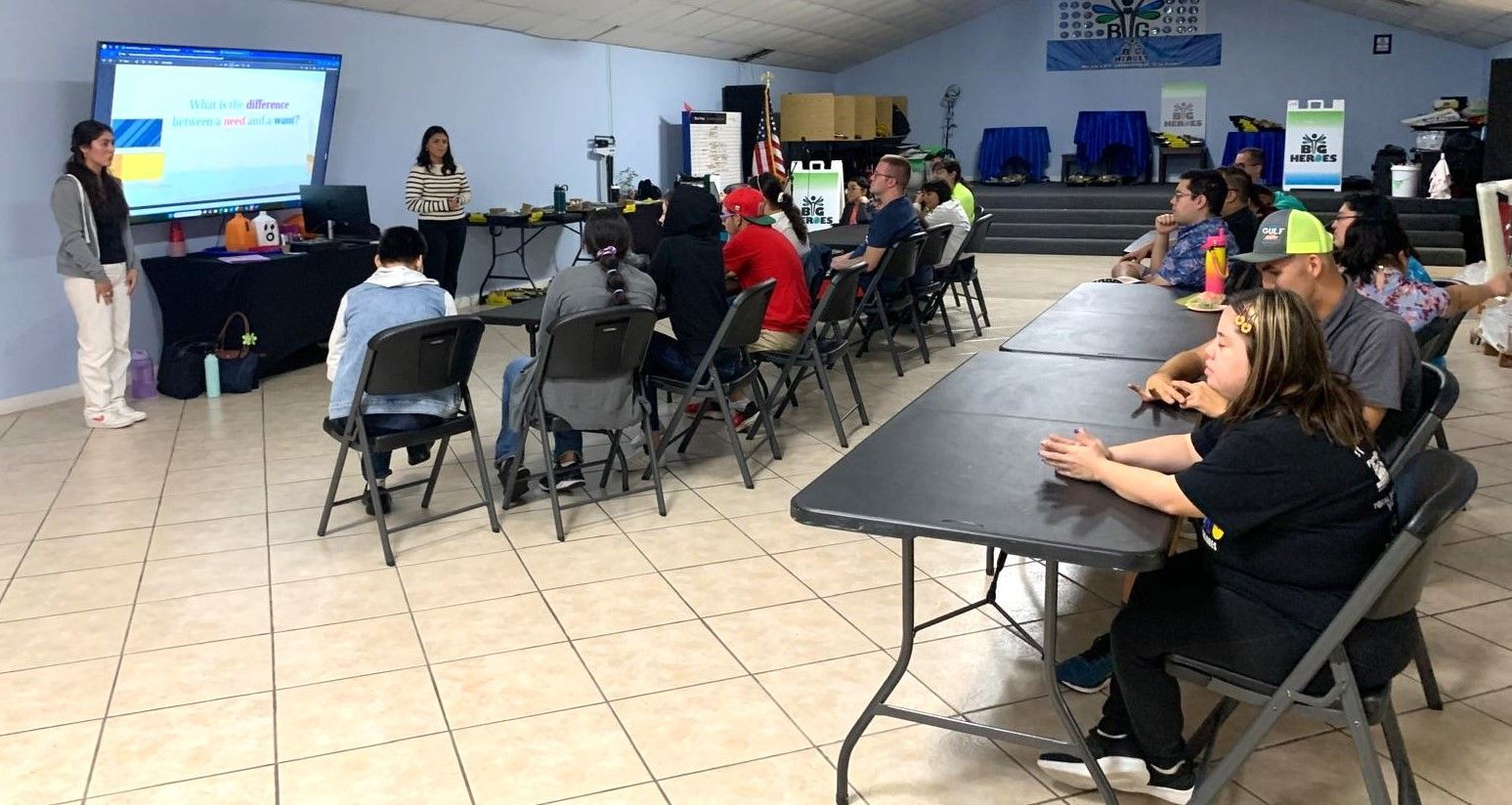 A group of people are sitting at tables in a room.