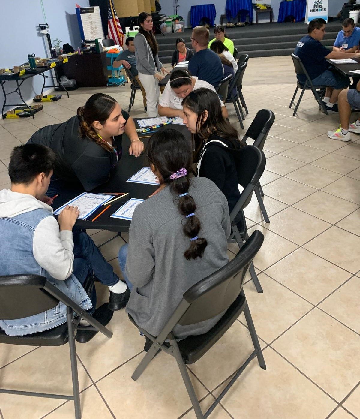 A group of people are sitting around a table in a room