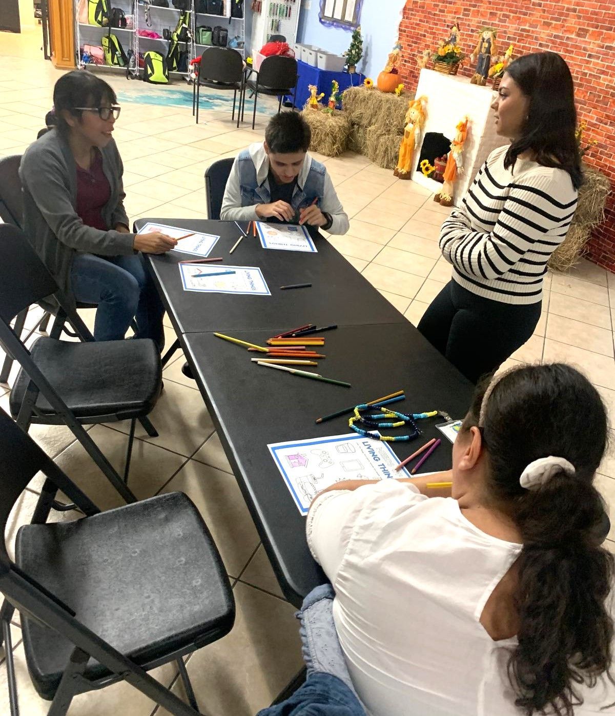A group of people are sitting around a table in a room.