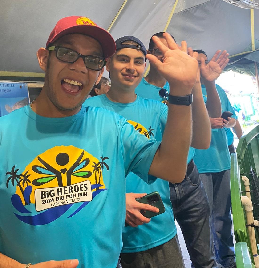 A group of men wearing blue shirts that say big heroes