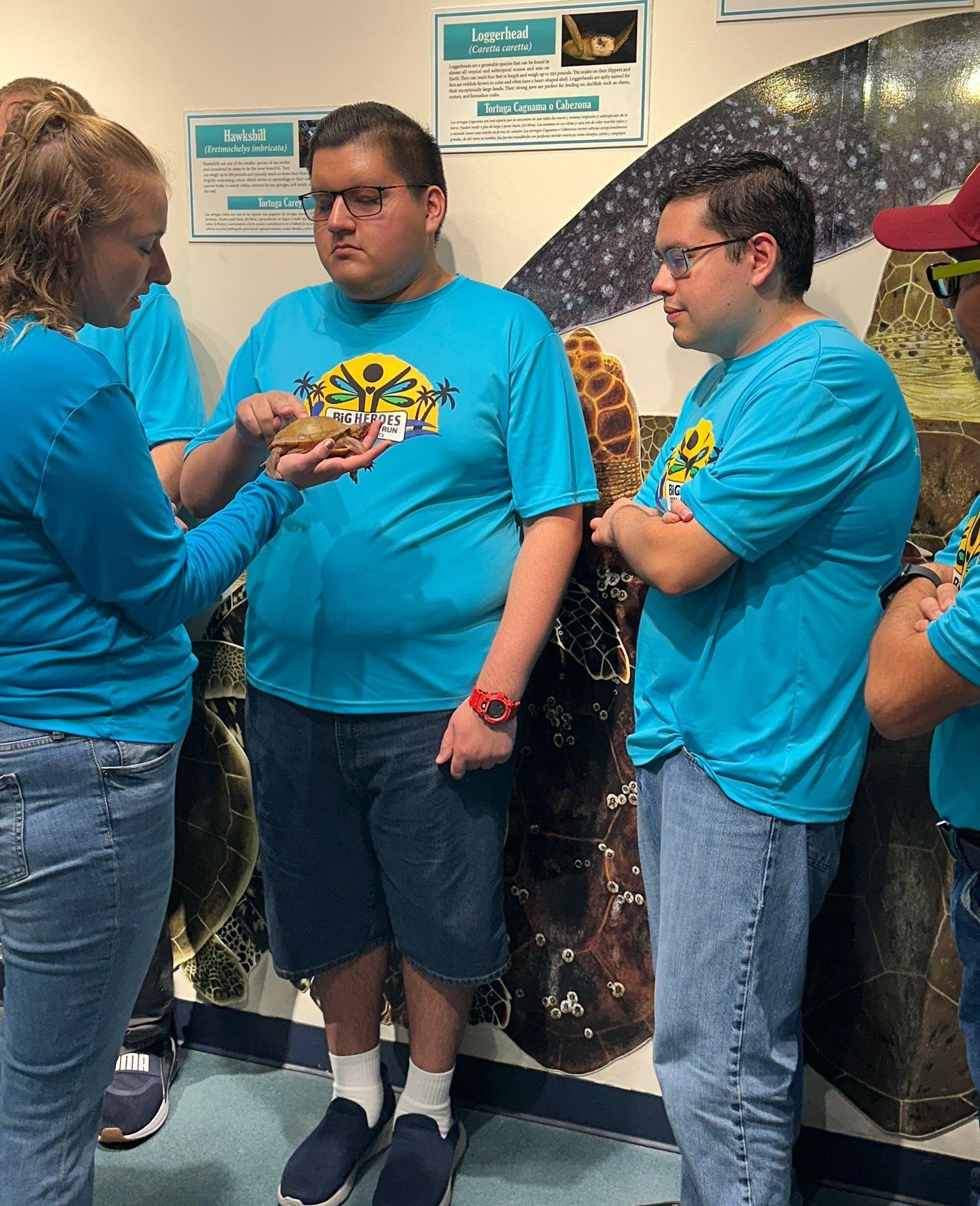 A group of people in blue shirts are standing next to each other