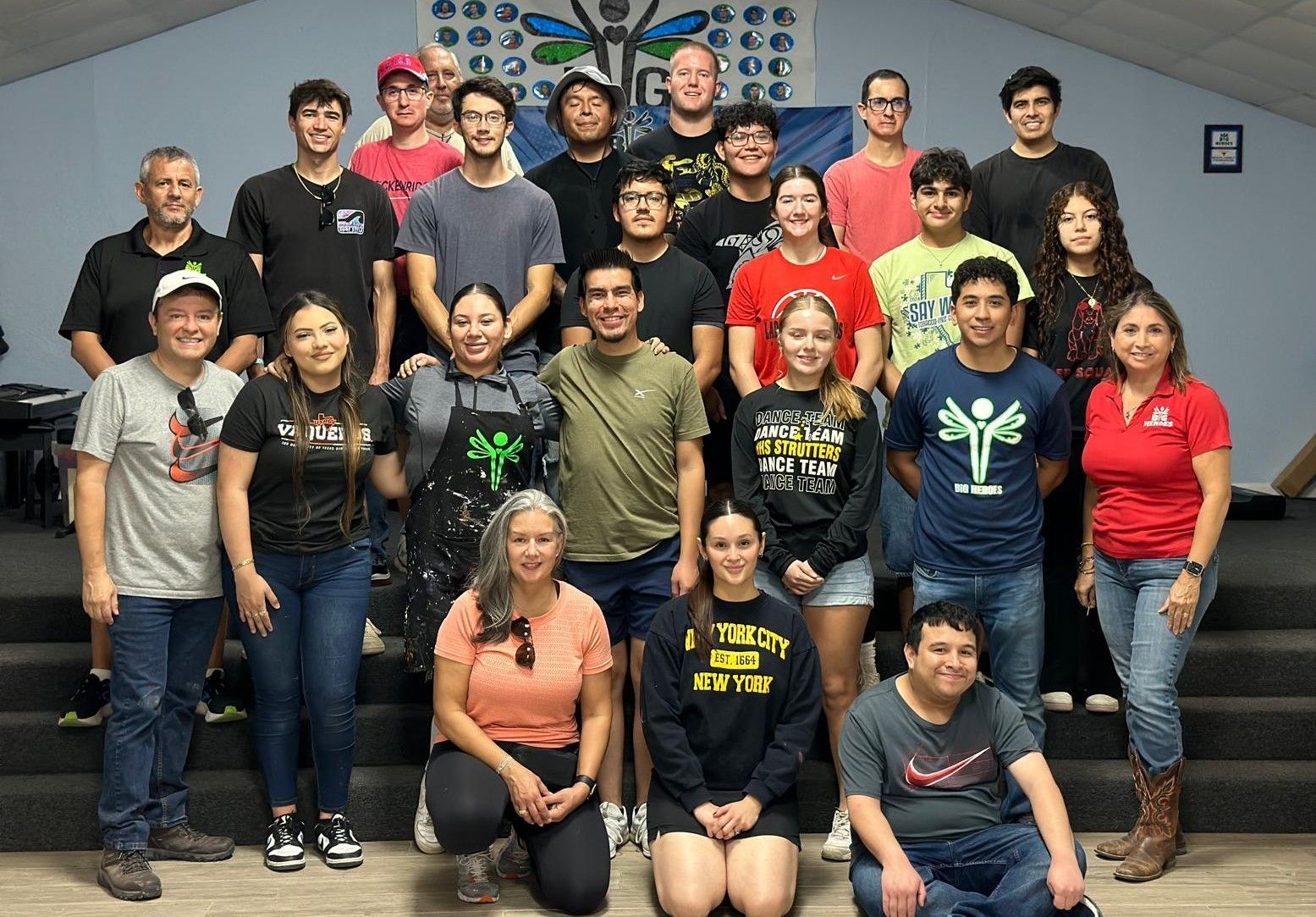 A group of people are posing for a picture in a room.