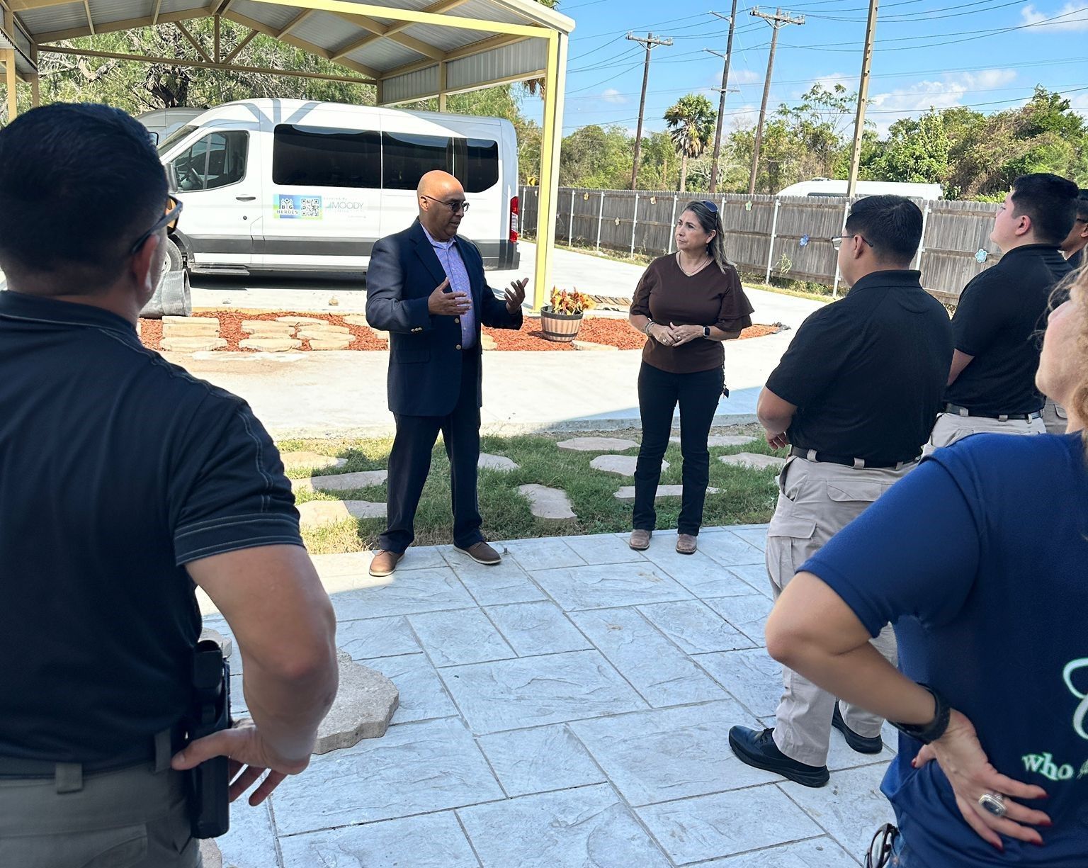 A man in a suit is talking to a group of people