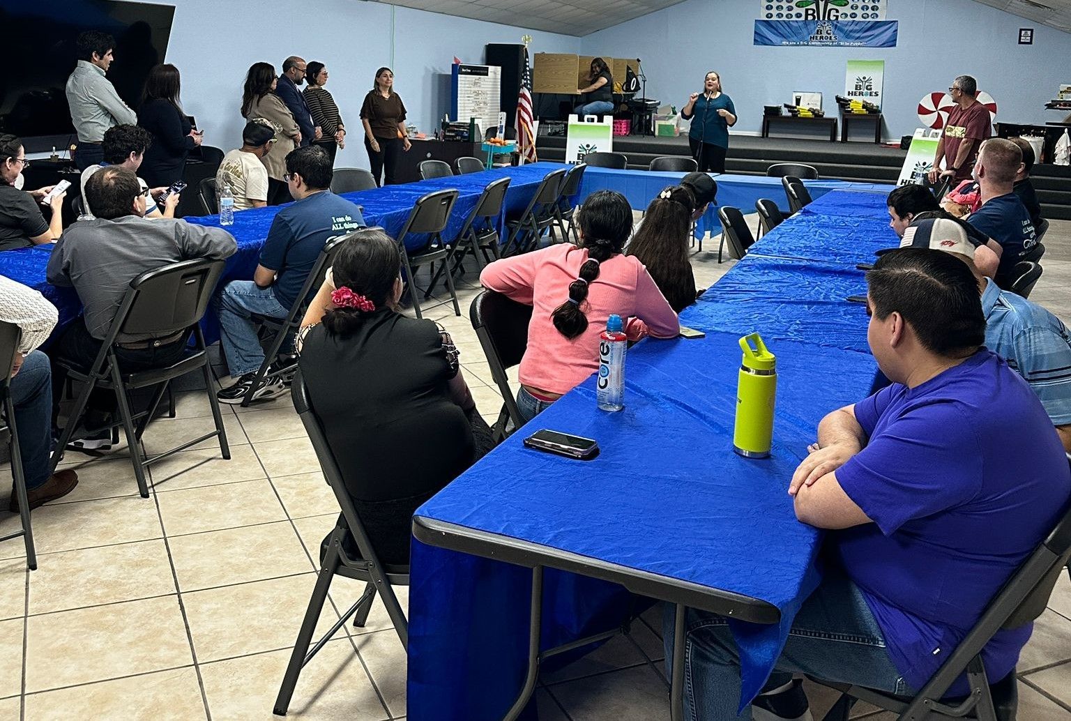 A group of people are sitting at tables in a room.