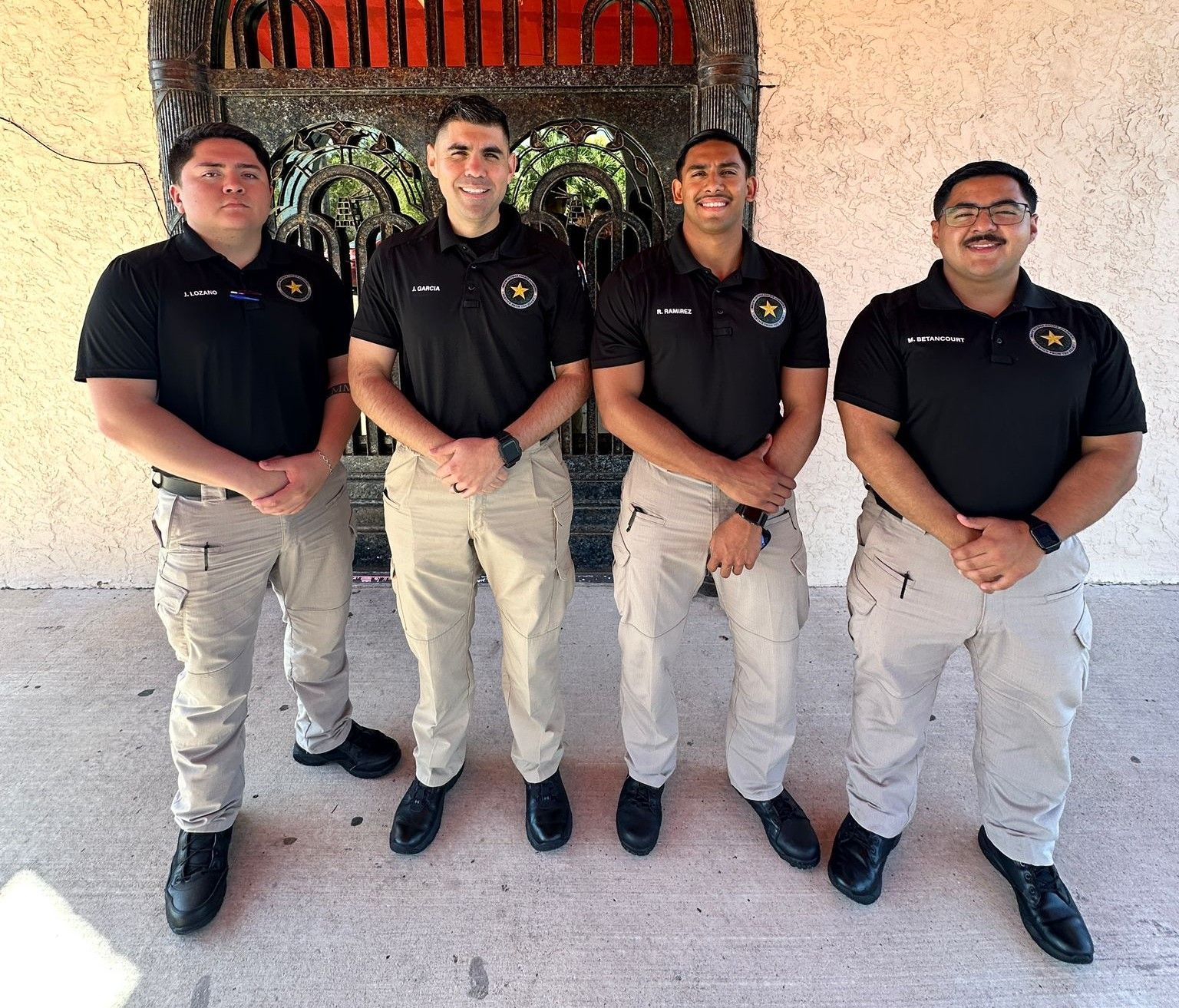 A group of men standing next to each other in front of a building