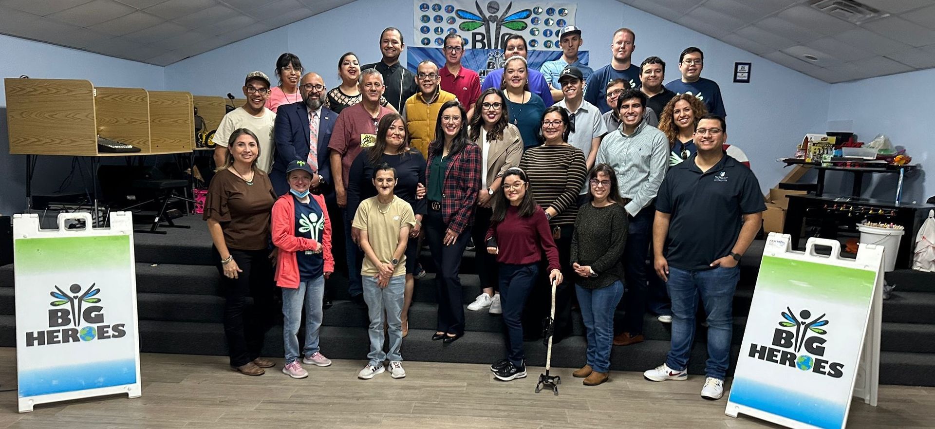 A large group of people are posing for a picture in a room.