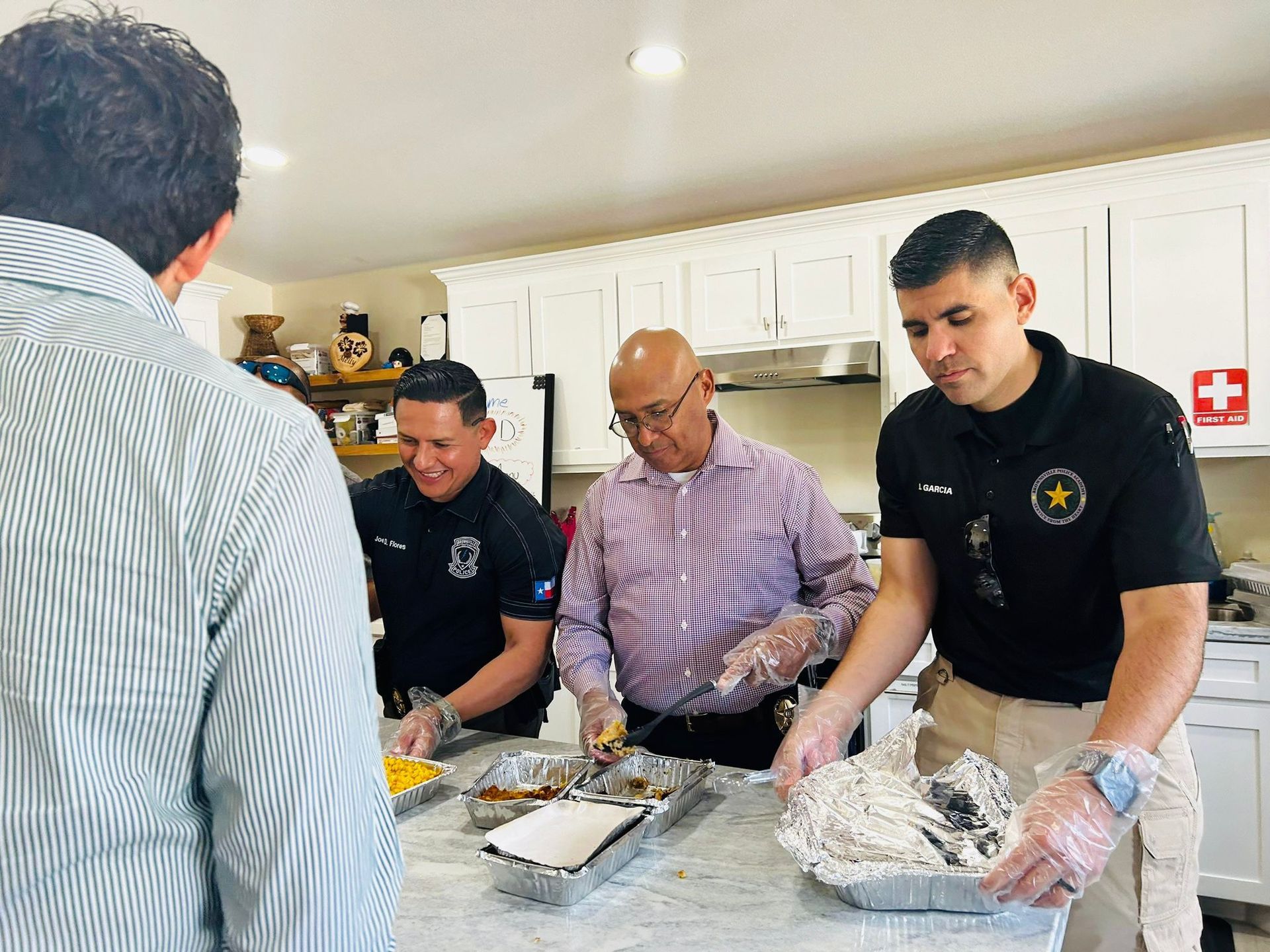 A group of men are preparing food in a kitchen.