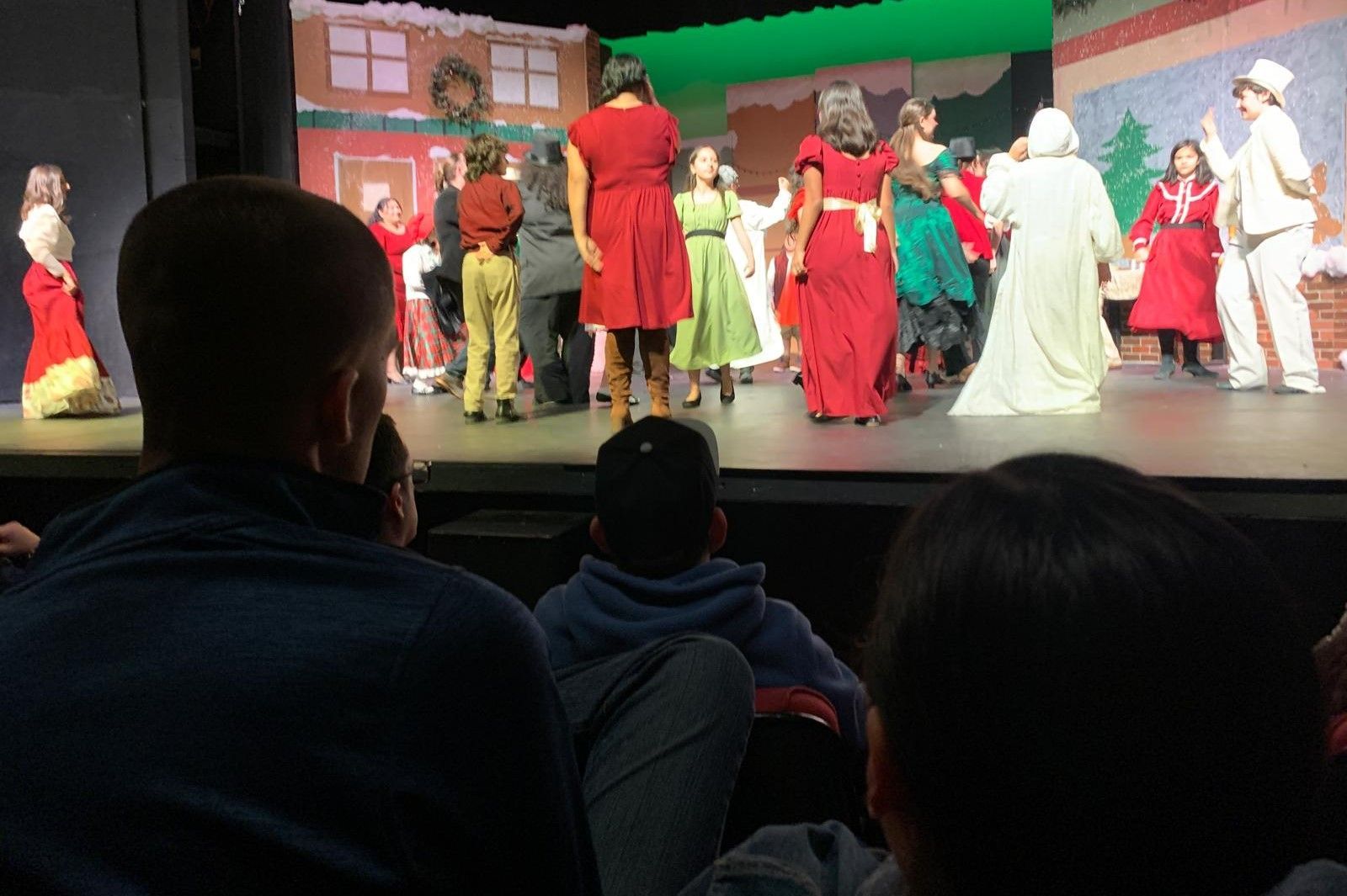 A group of people are watching a play on a stage.