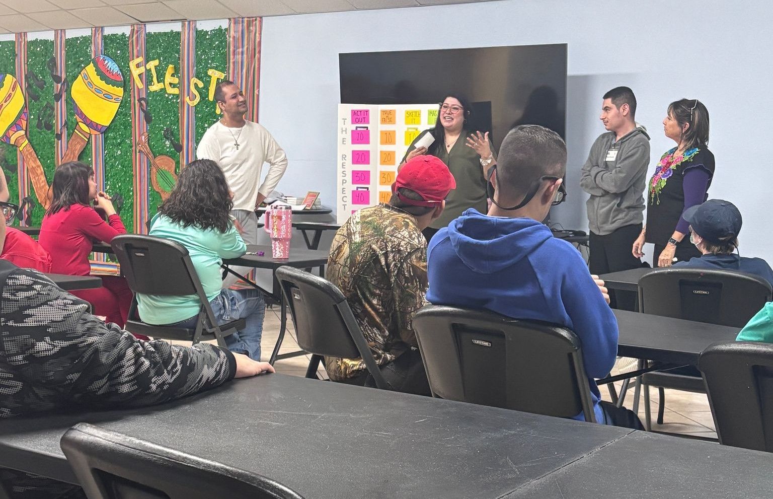 A group of people are sitting at tables in a room.