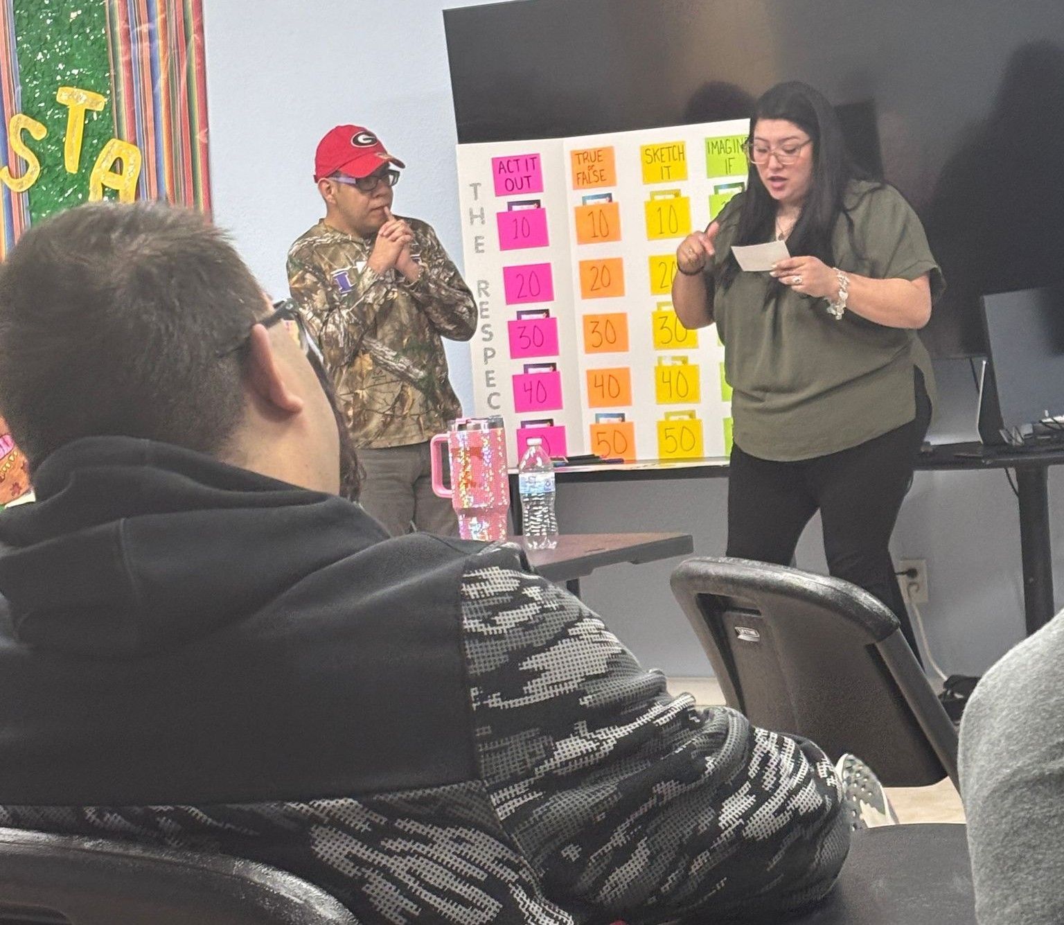 A woman is giving a presentation to a group of people