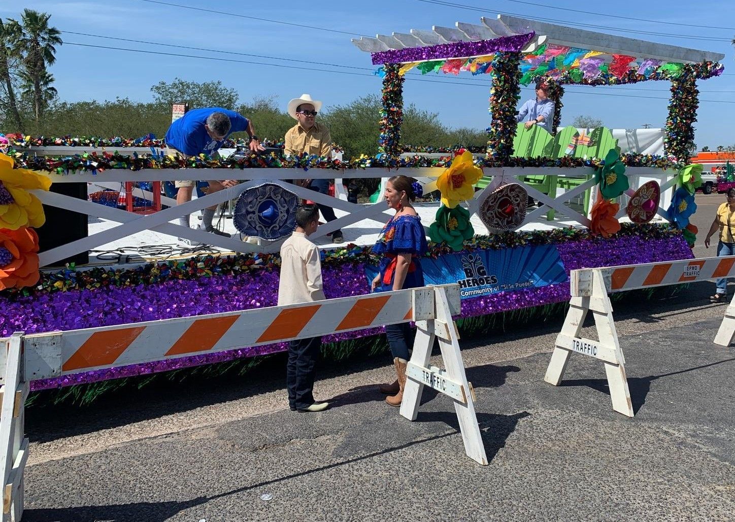 A group of people are standing in front of a parade float.