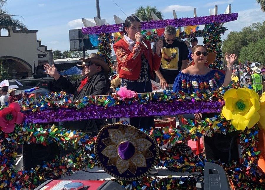 A group of people are riding on a colorful float in a parade.