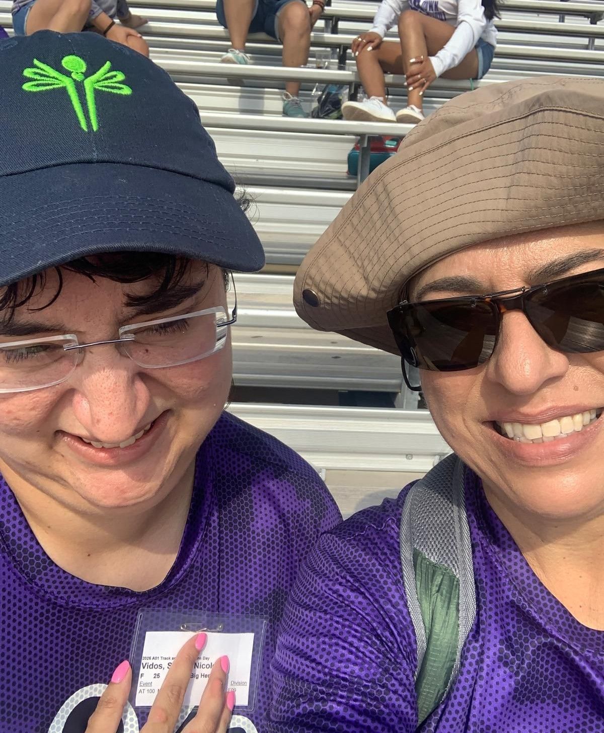 Two women wearing hats and sunglasses are posing for a picture