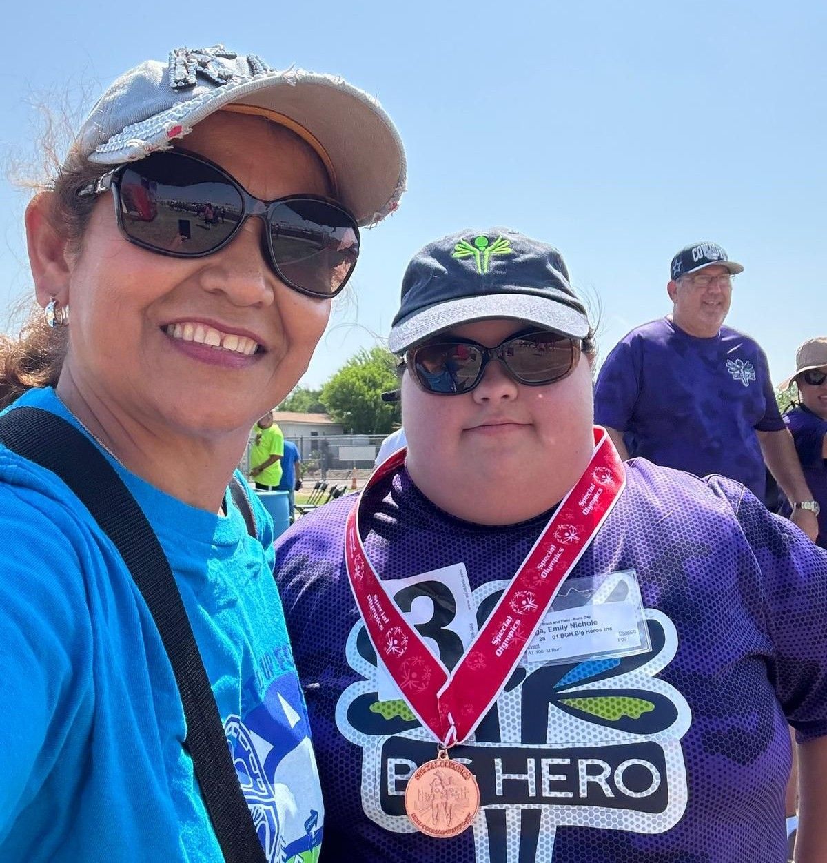 A man wearing a purple shirt with the word hero on it