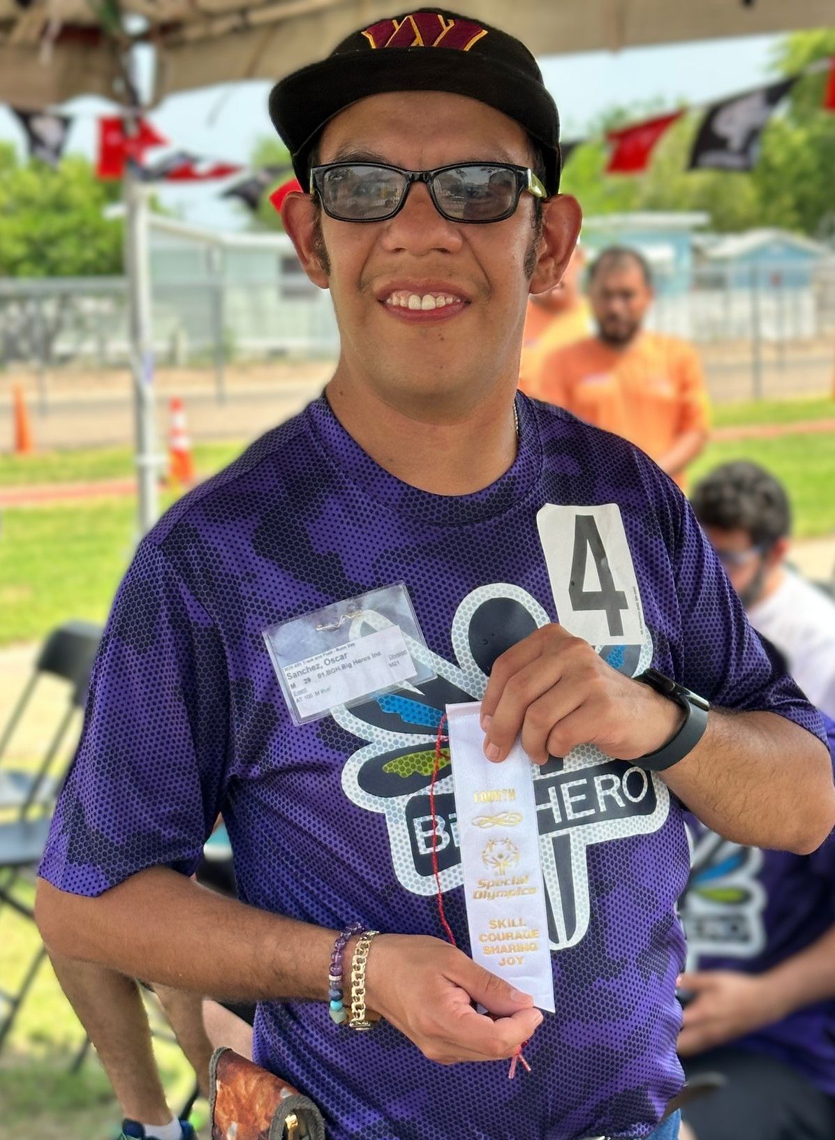 A man wearing a purple shirt with the number 4 on it