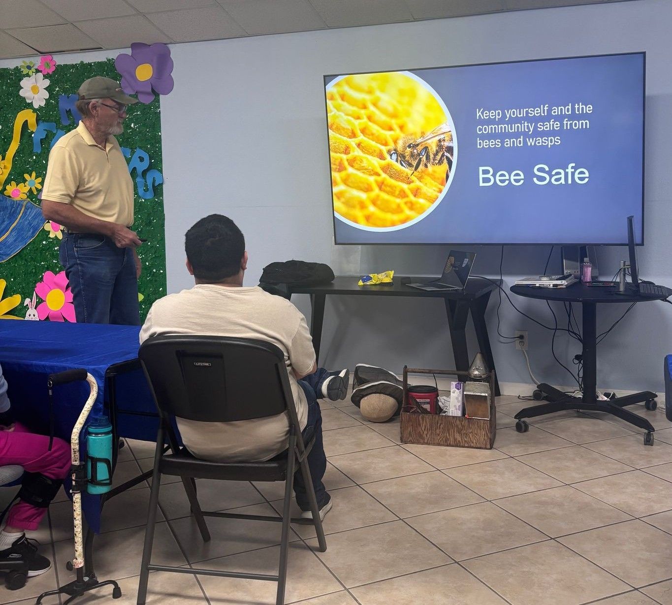 A man is giving a presentation about bee safe