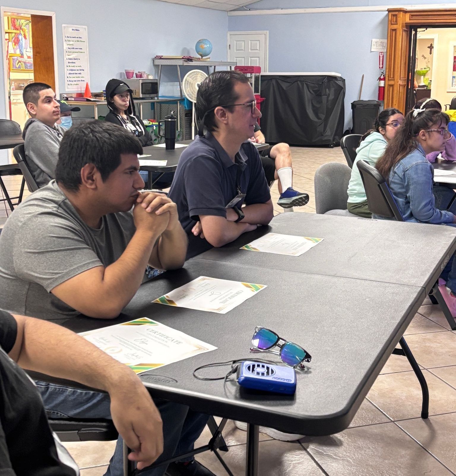 A group of people are sitting at tables in a room