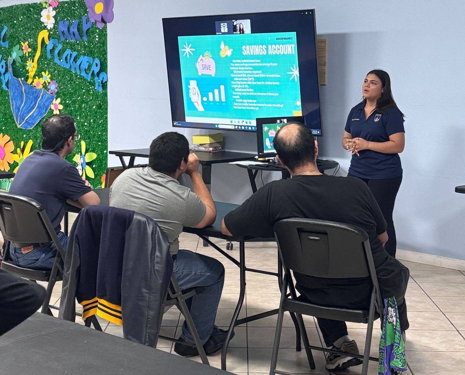 A woman is giving a presentation to a group of people