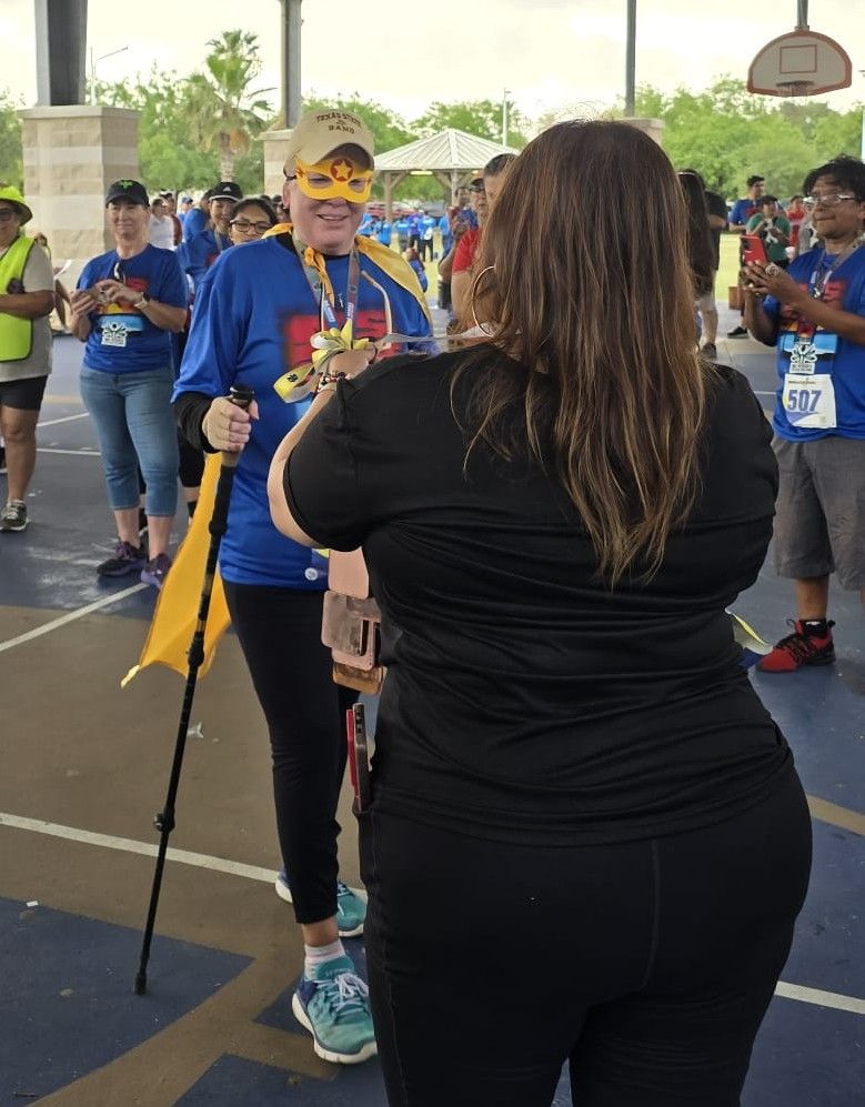 A group of people are standing on a basketball court.