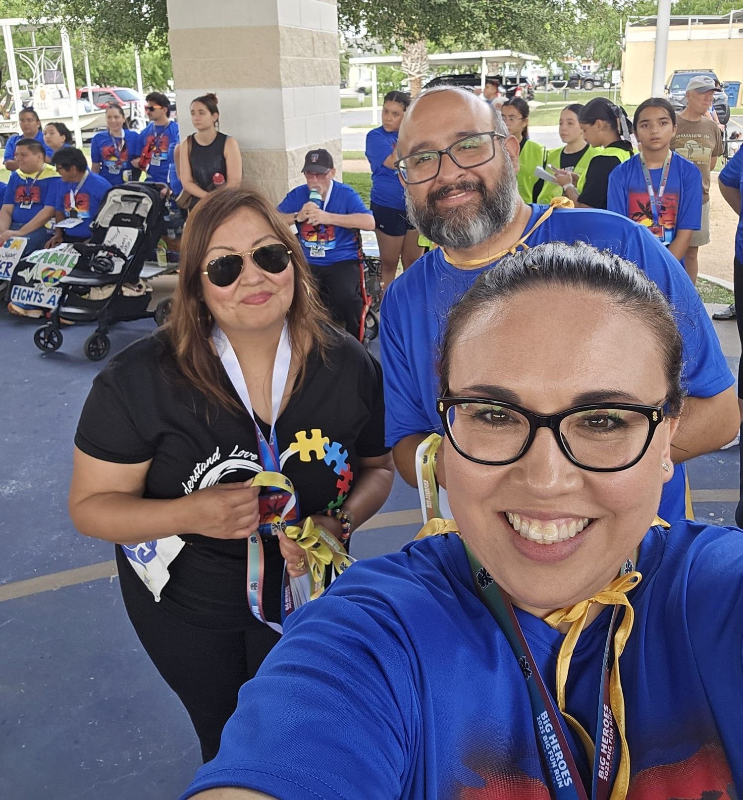A group of people are posing for a picture with one woman wearing glasses