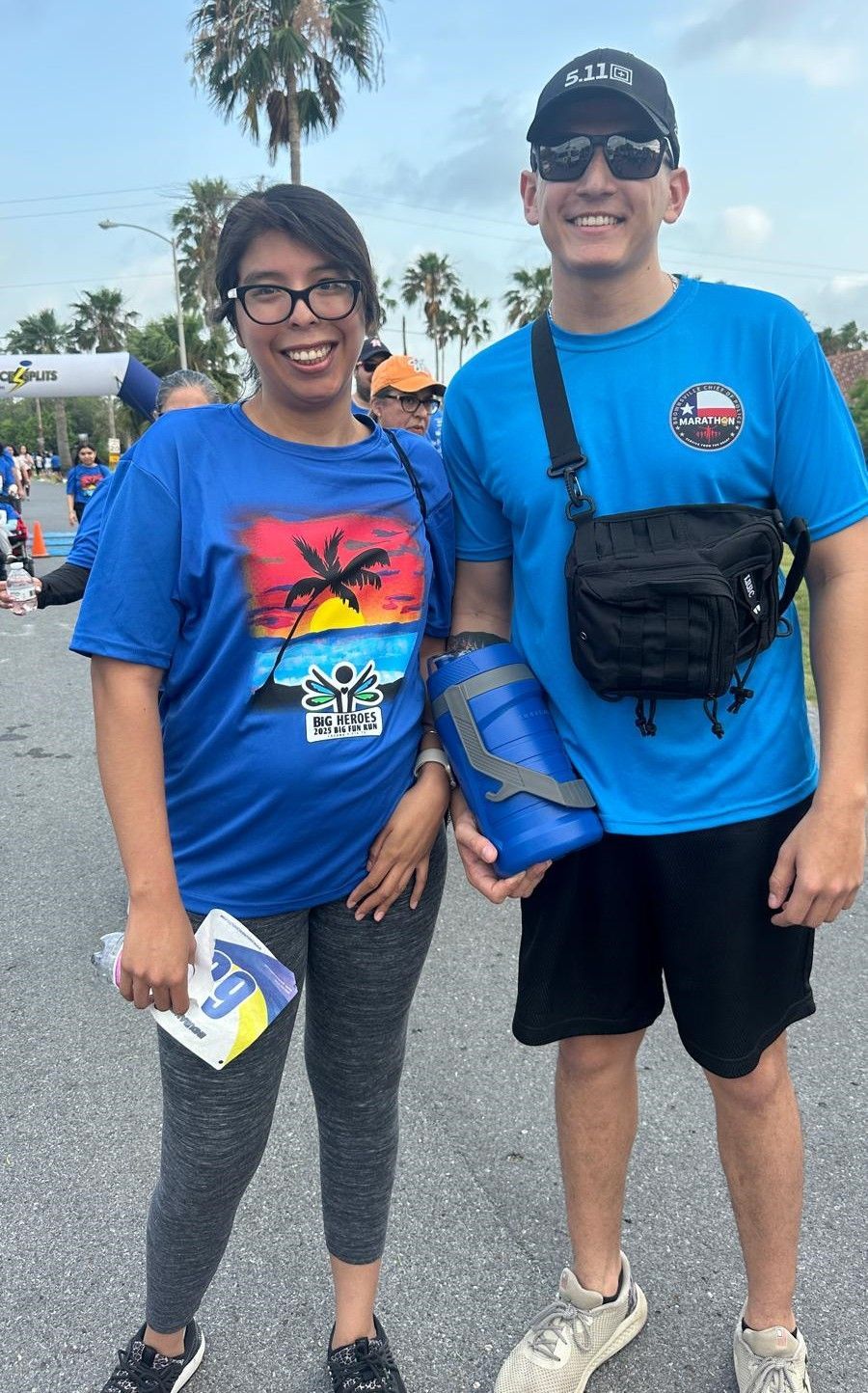 A man and a woman are standing next to each other on the street.