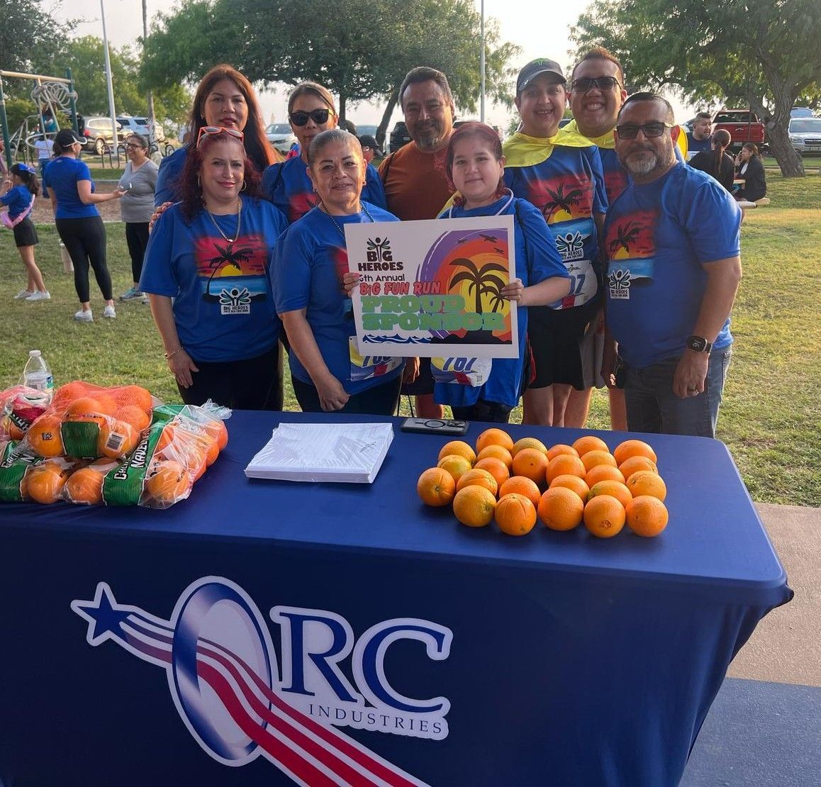 A group of people standing around a table that says rc on it