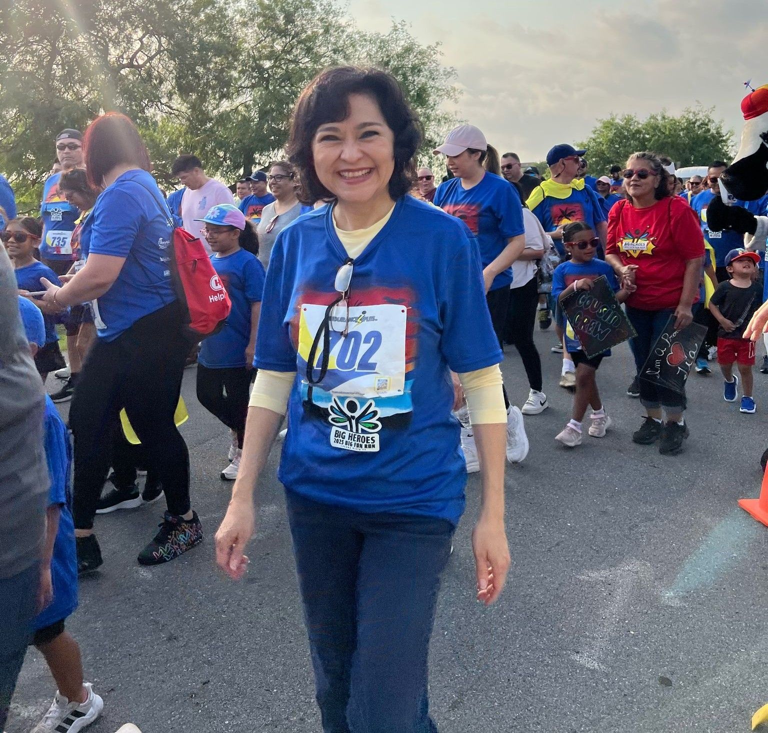A woman wearing a blue shirt with the number 702 on it