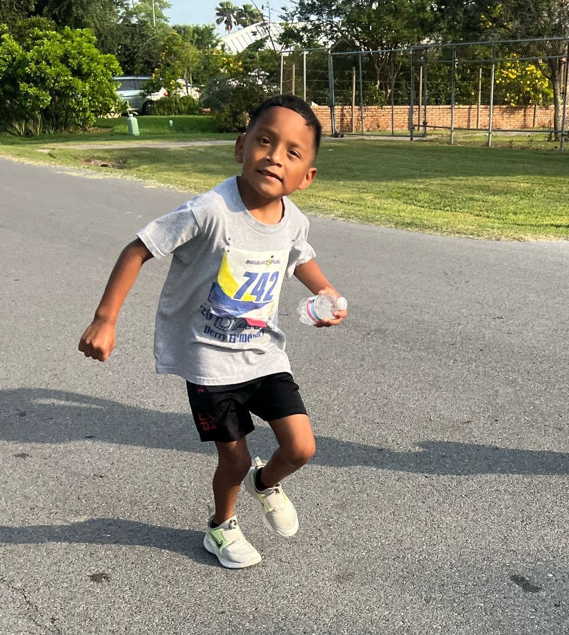 A young boy wearing a shirt with the number 747 on it