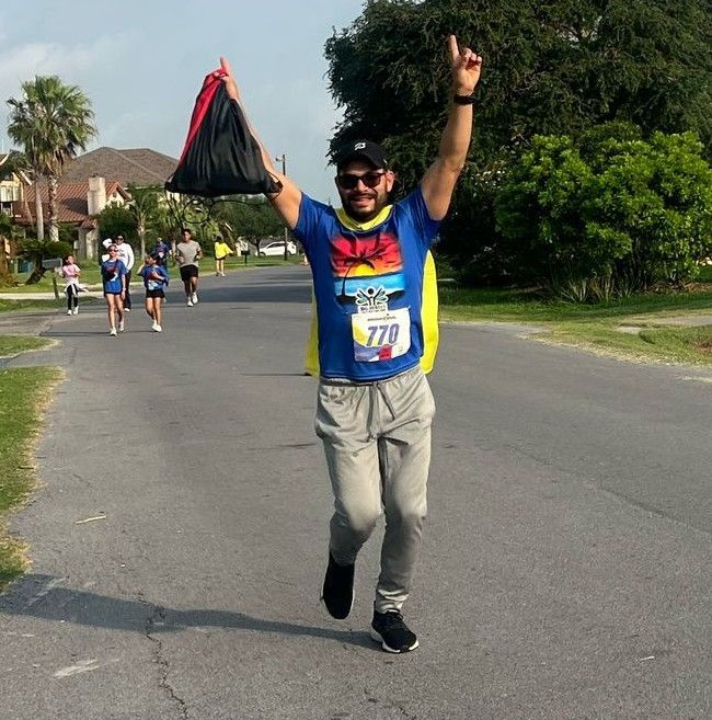A man with the number 779 on his shirt is running down a street
