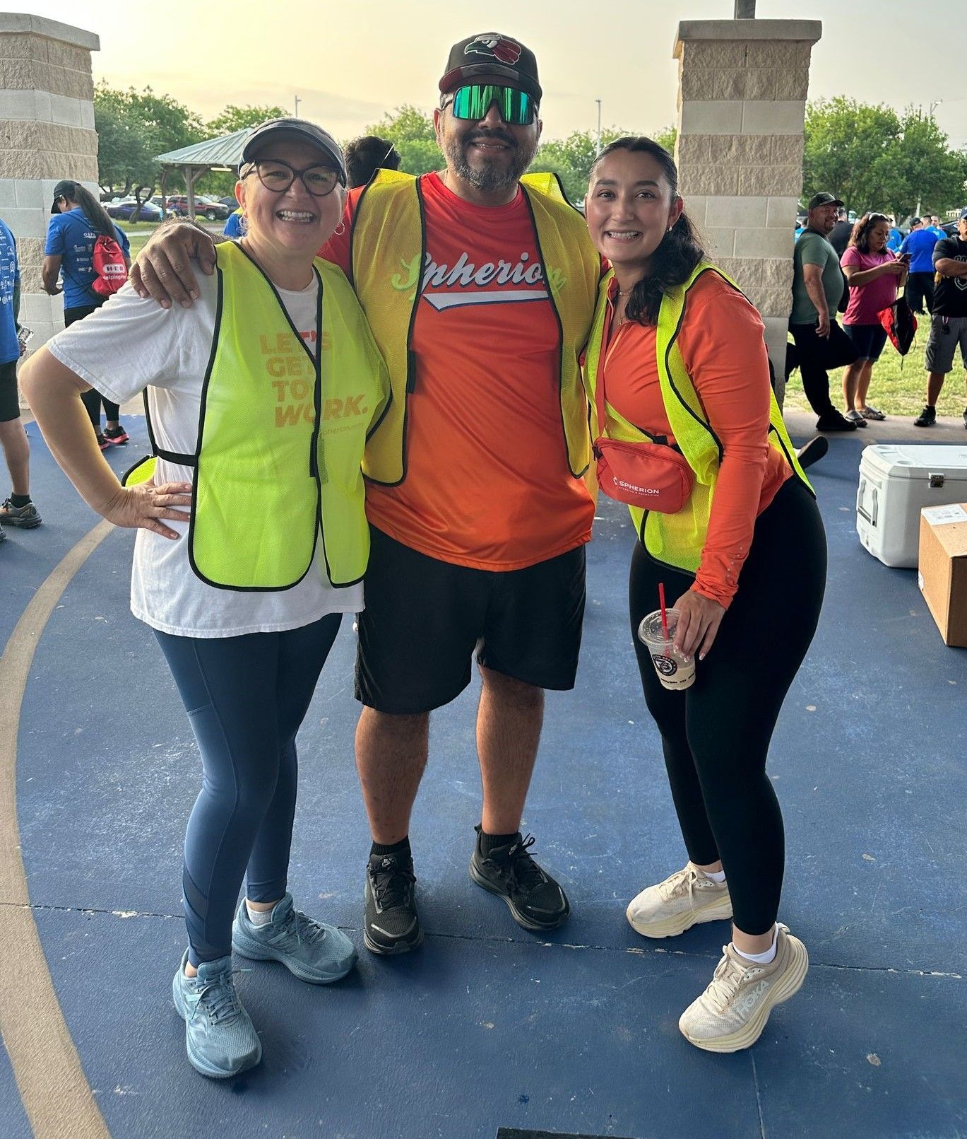 A man and two women are posing for a picture together