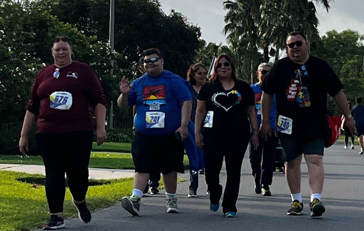 A group of people are walking down a street.