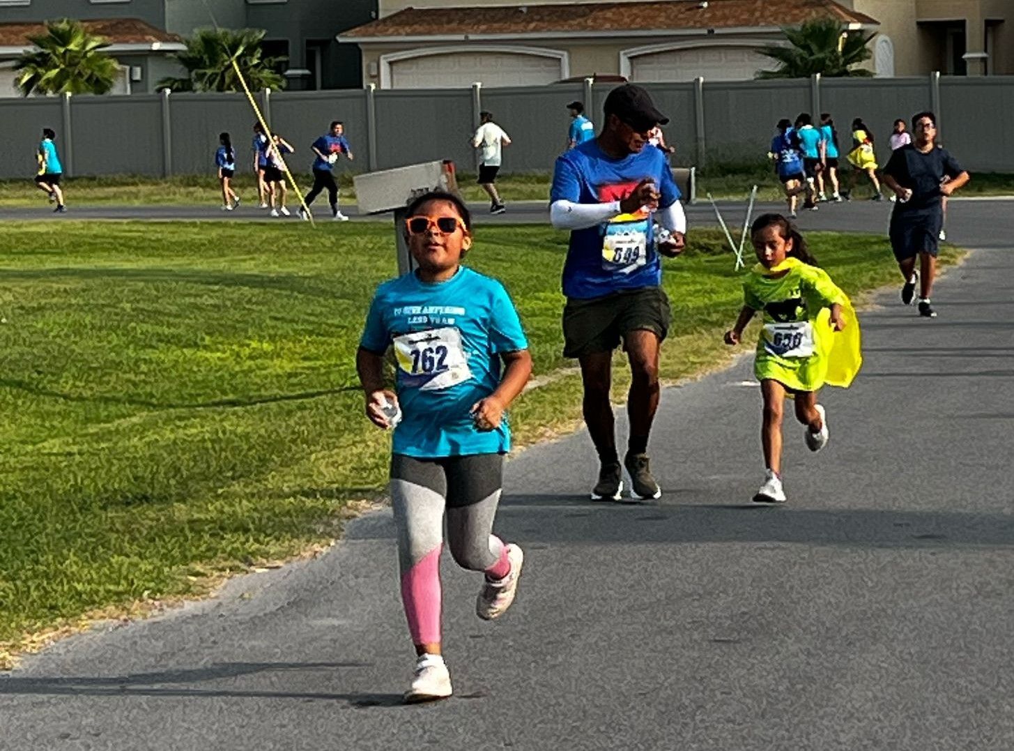 A group of people are running a race on a road.