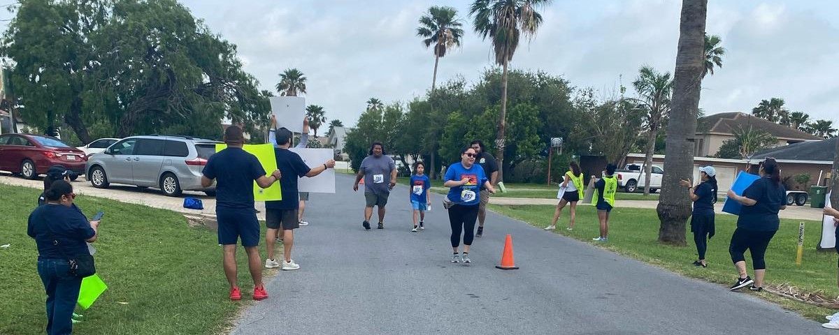 A group of people are running down a street.