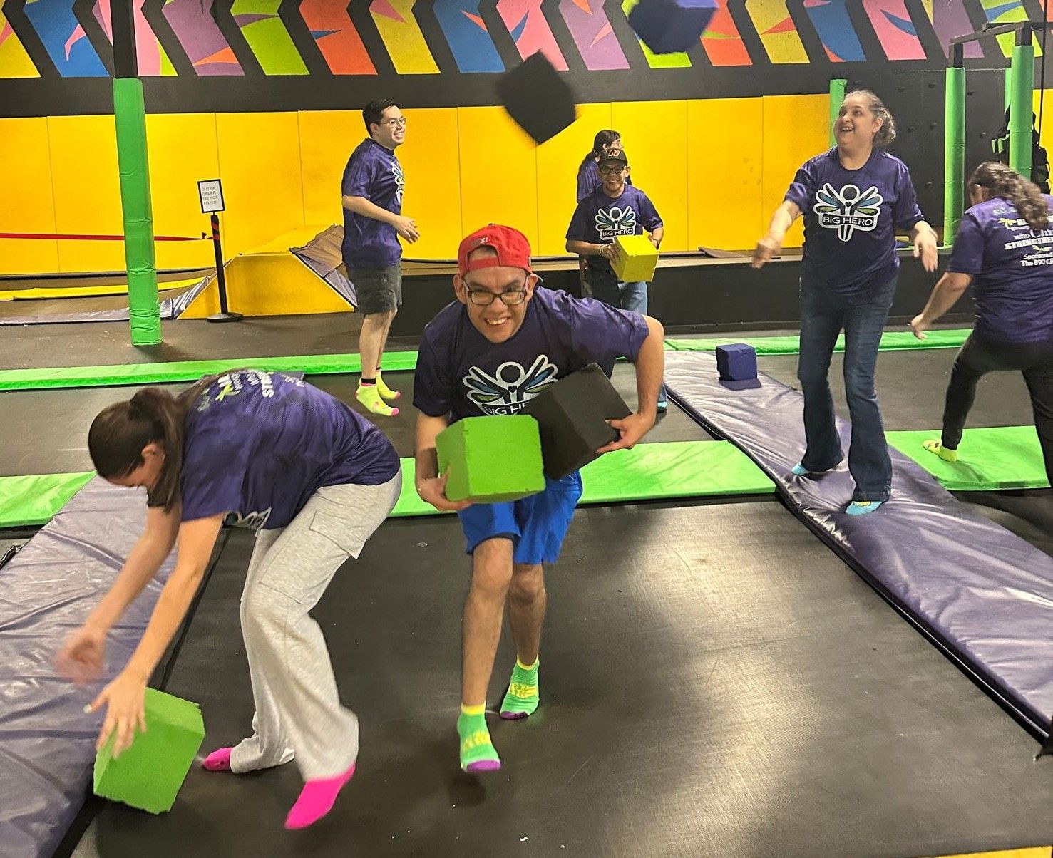 A group of people are playing a game on a trampoline.