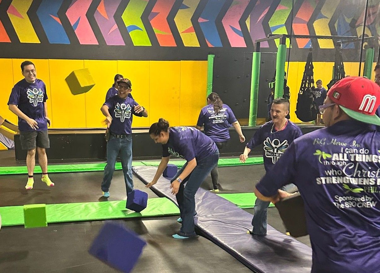 A group of people are playing a game on a trampoline.