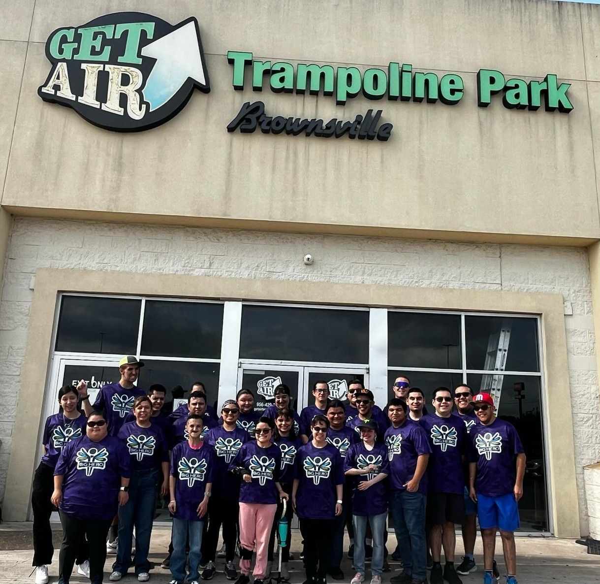 A group of people pose in front of the get air trampoline park