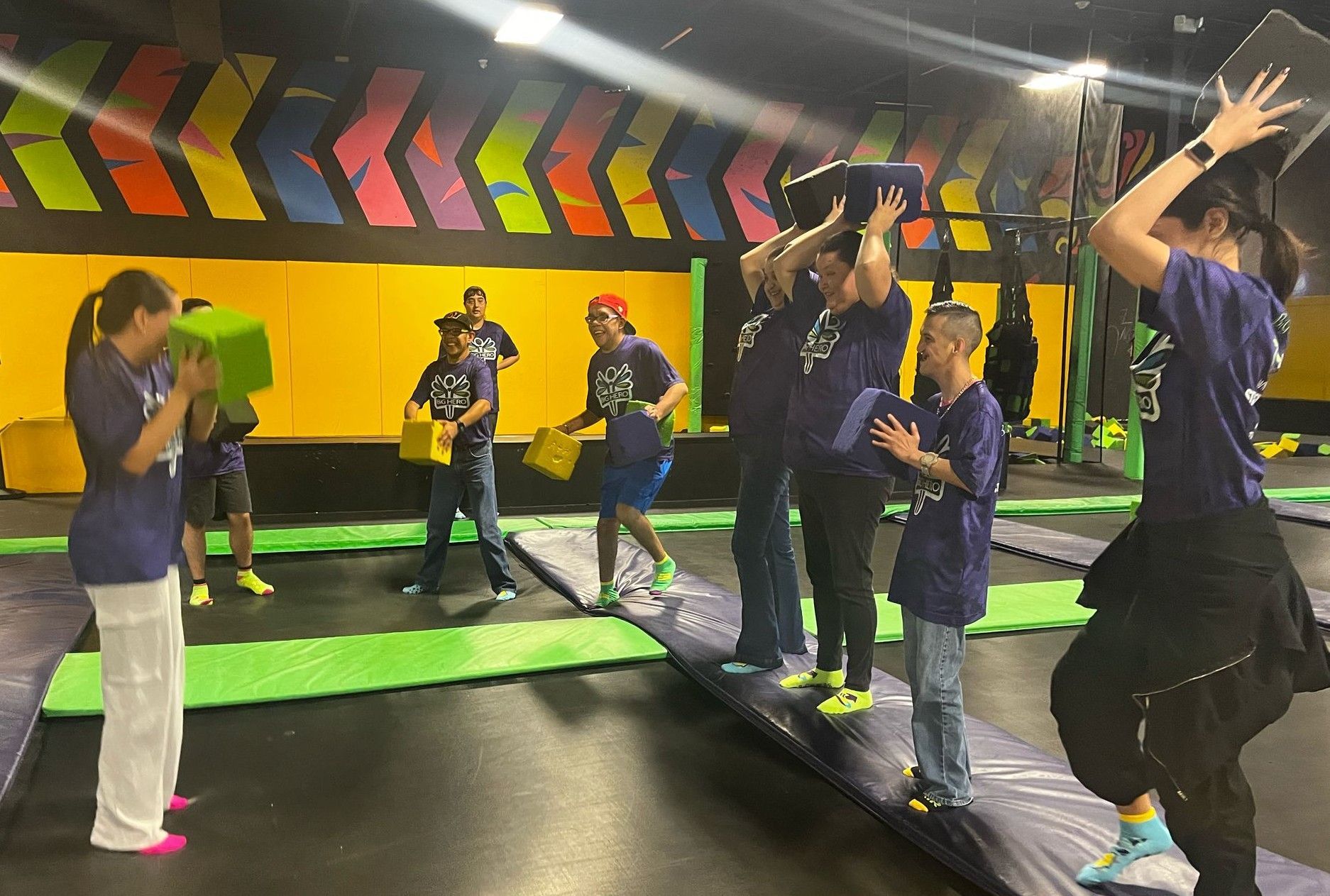 A group of people are playing a game on a trampoline.