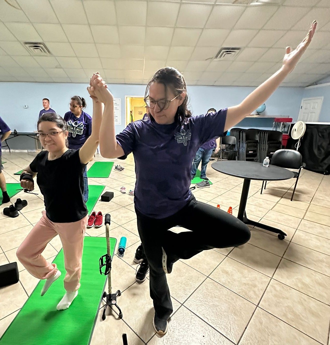 A group of people are doing yoga in a room