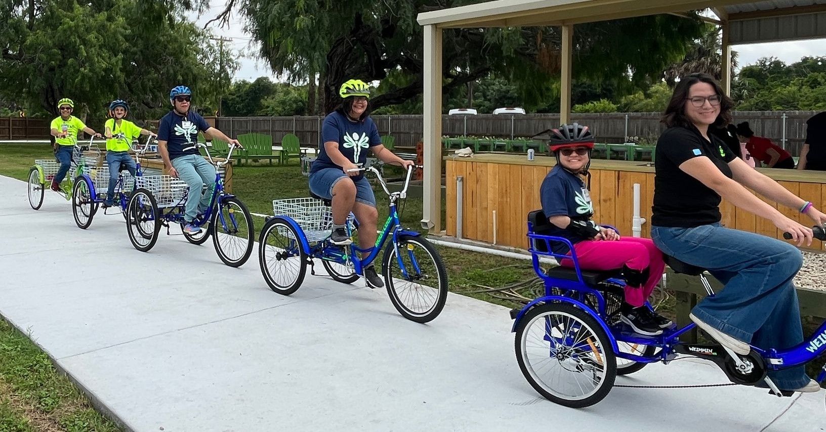 A group of people are riding bicycles on a sidewalk.