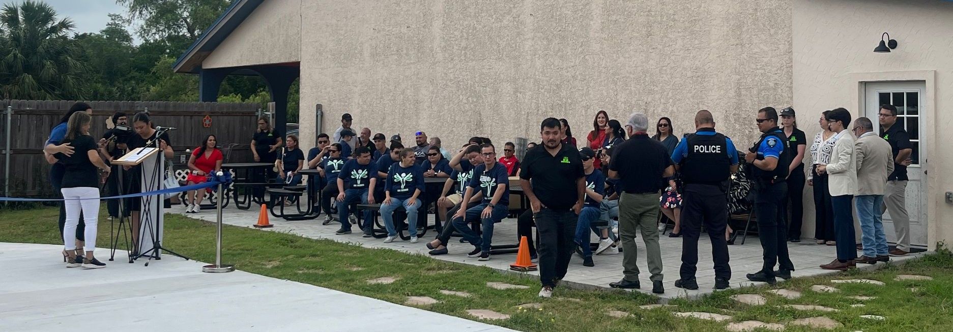 A large group of people are standing in front of a building.