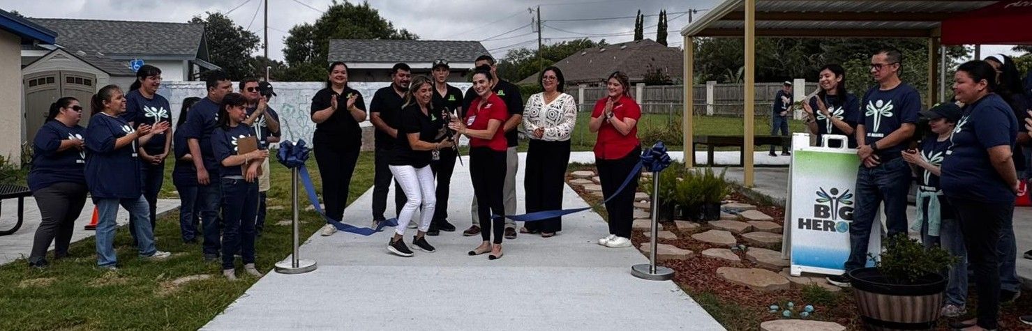 A group of people are standing in front of a microphone.