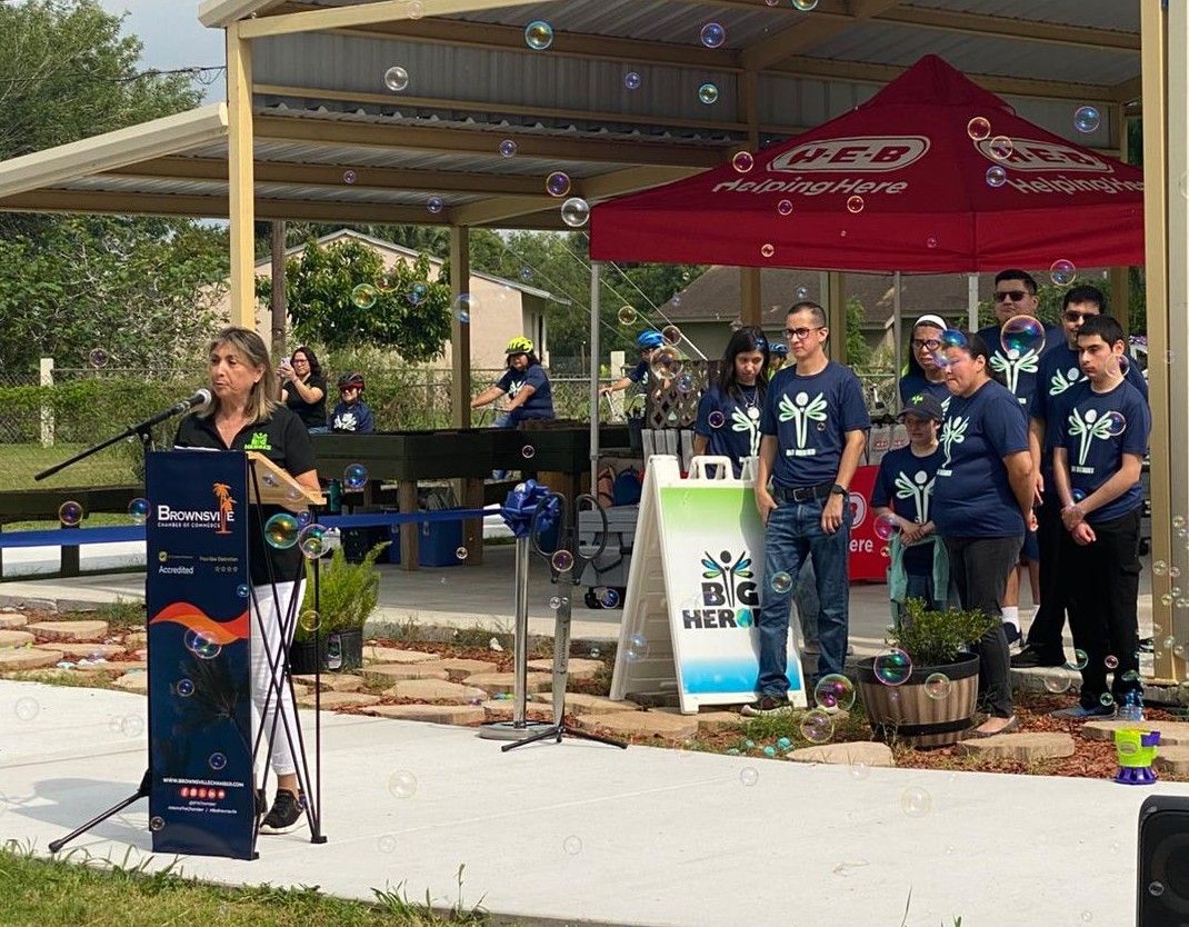 A woman is standing at a podium giving a speech in front of a crowd.