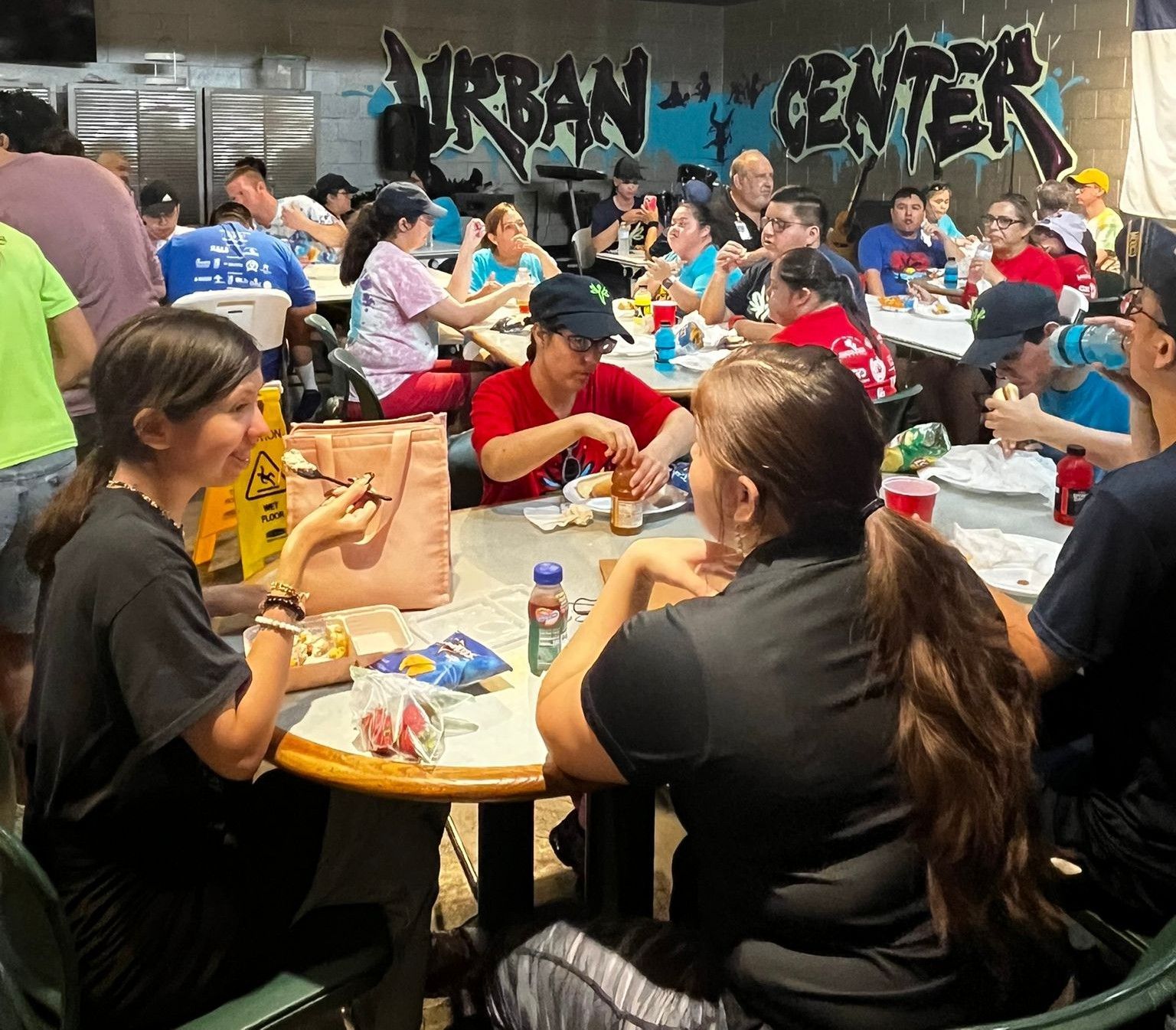 People seated at round tables eating in the