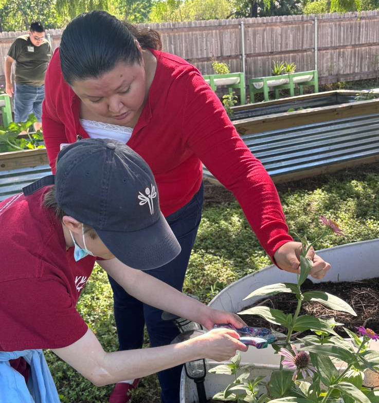 A group of people are posing for a picture in front of a building.