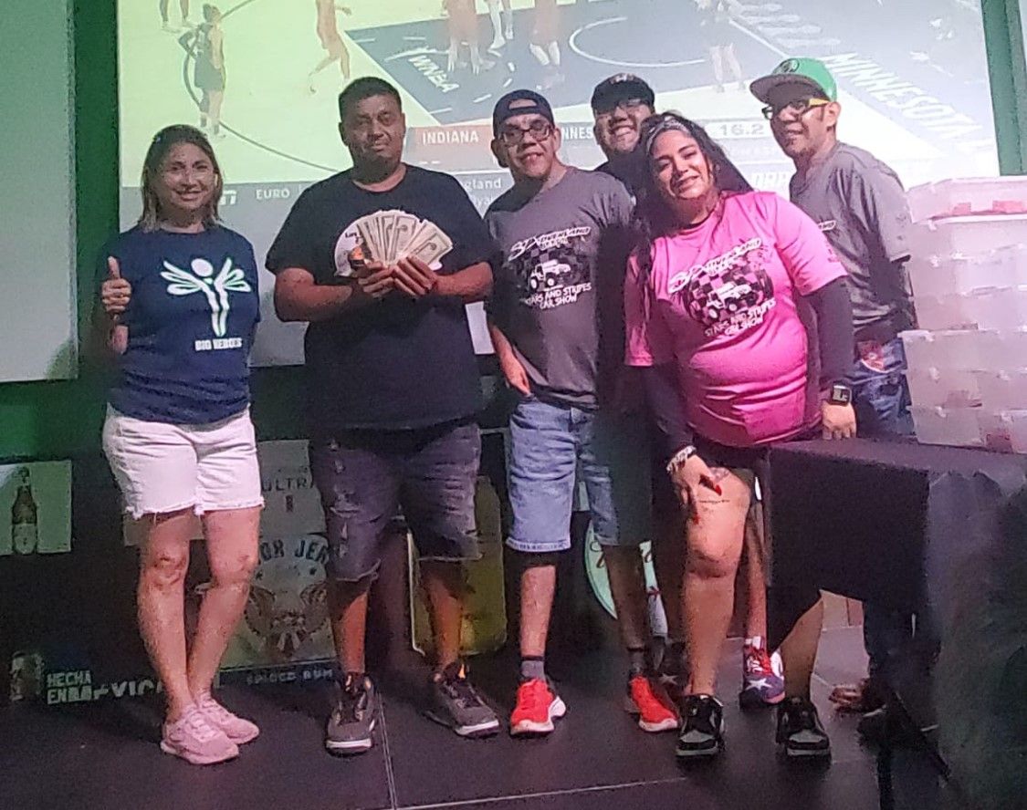A group of people are posing for a picture on a stage.